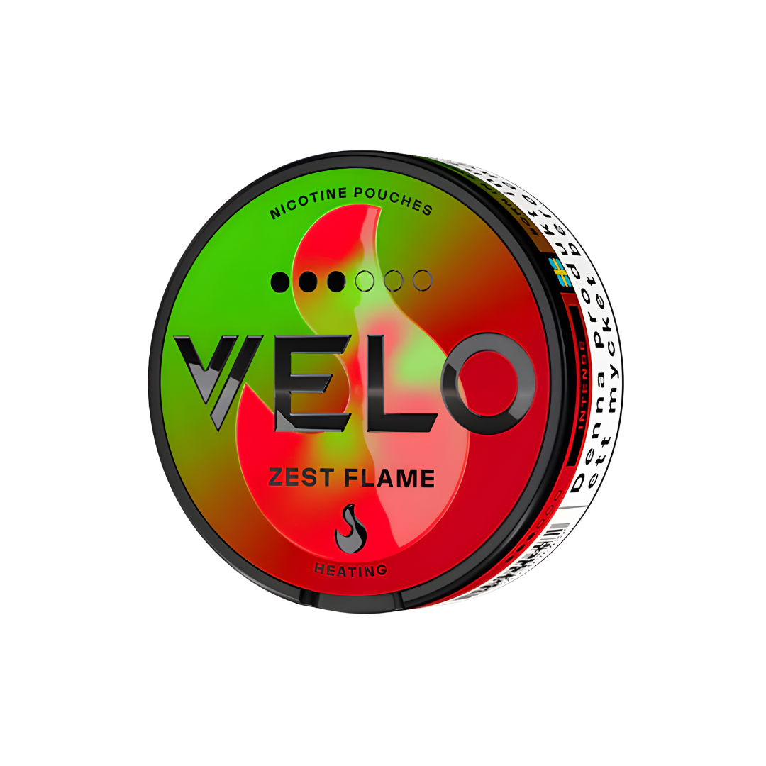 Detail close-up of the Velo Zest Flame snus can featuring a colorful design with red, green, and black elements.