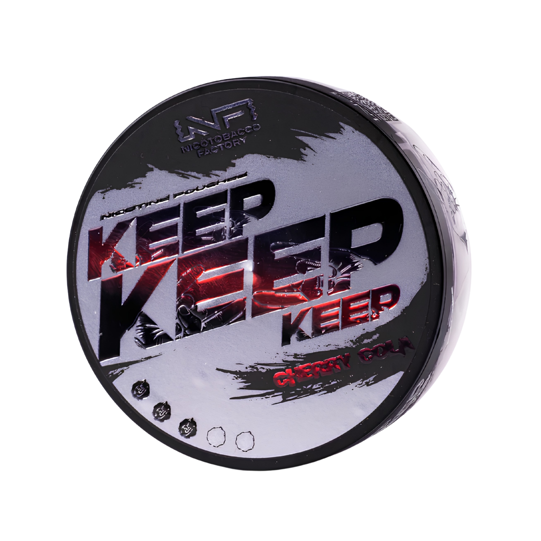 Detail close-up of a circular black, red, and white container featuring text branding and a screw top