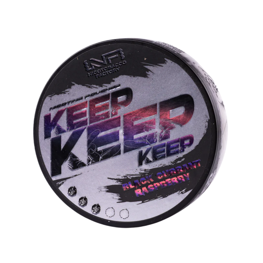 Detail close-up of Keep Black Currant Raspberry packaging showcasing bold black, purple, and pink colors on a white backgr…