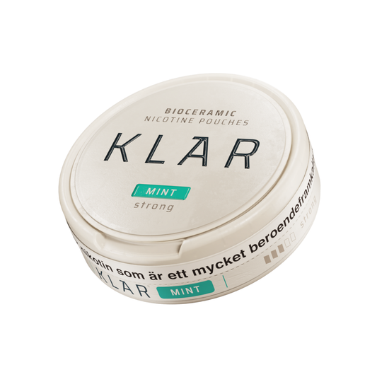 Detail close-up of the round teal Klar Mint Strong Mini container with a screw top on a white background