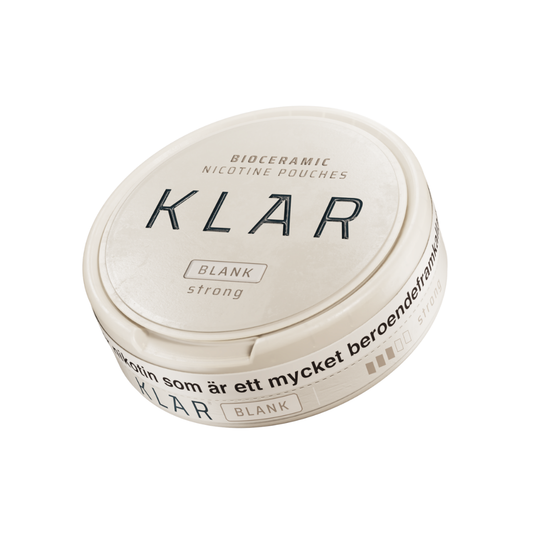 Detail close-up of the round white container with a black label and screw top for Klar Blank Strong Mini
