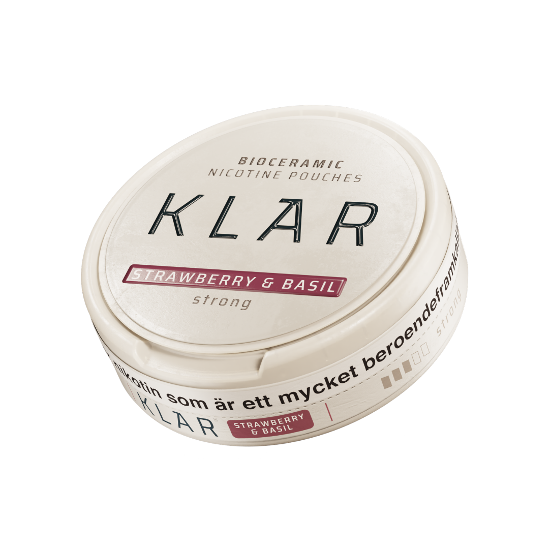 Detail close-up of the round Klar cream container with a red label and screw top on a white background