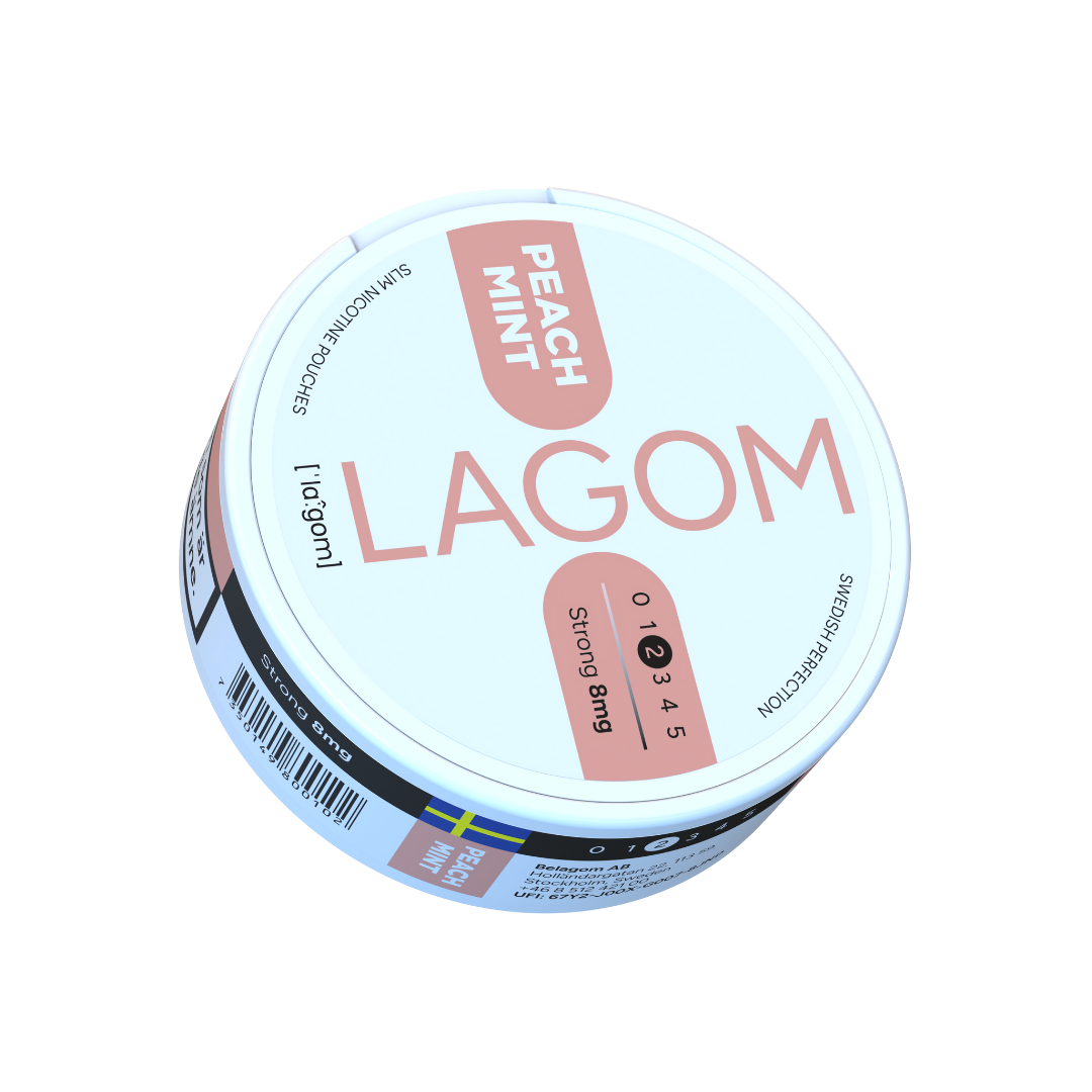 Detail close-up of the round Lagom Peach Mint container showcasing a colorful pink and white design.