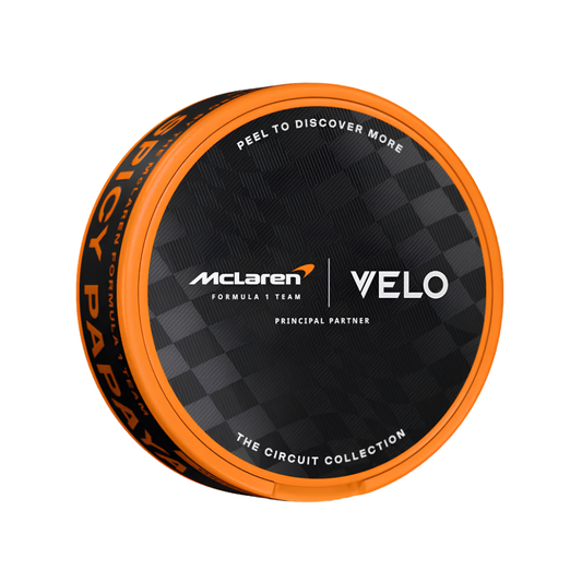Front view of the black and orange Velo McLaren Spicy Papaya Slim can showcasing flavor description.