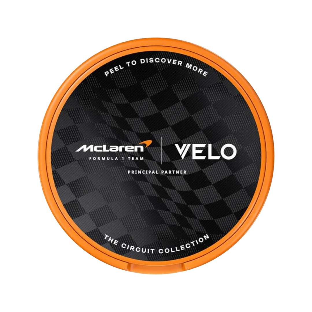 Front view of the black and orange Velo McLaren Spicy Papaya Slim can featuring brand logo and flavor details.