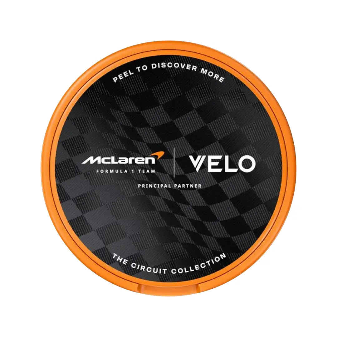 Velo McLaren Spicy Papaya Slim snus can with vibrant packaging, featuring bold graphics and product branding.