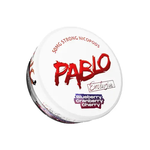 Pablo Exclusive Blueberry Cranberry Cherry smoothie in a clear glass with fresh blueberries, cranberries, and cherries.