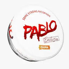 Close-up of a glass bottle of Pablo Exclusive Cola showing the label with the brand name and classic cola branding.